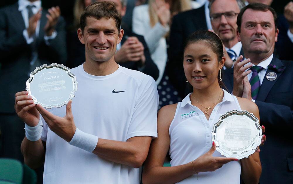 Max Mirnyi of Belarus and Hao-Ching Chan of Taiwan hold their runners up trophies after being defeated by Nenad Zimonjic of Serbia and Samantha Stosur of Australia in the mixed doubles final at the All England Lawn Tennis Championships in Wimbledon.