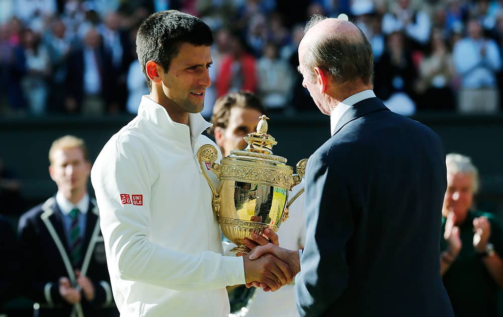 Duke of Kent shakes hands with Novak Djokovic of Serbia after handing over the trophy after Djokovic defeated Switzerland's Roger Federer in the men's singles final match at the All England Lawn Tennis Championships in Wimbledon.