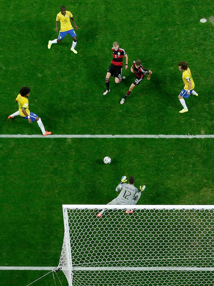 Germany's Andre Schuerrle (9) scores during the World Cup semifinal soccer match between Brazil and Germany at the Mineirao Stadium in Belo Horizonte, Brazil.