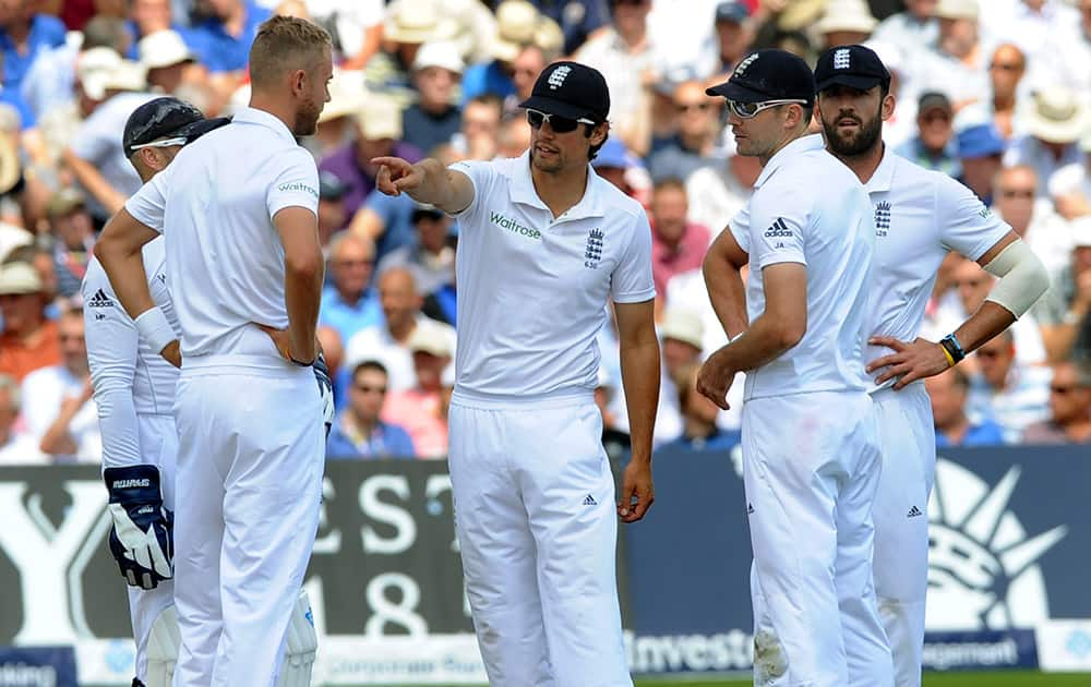 England captain Alastair Cook, center, gestures while talking to players, from second left to right, Stuart Broad, James Anderson and Liam Plunkett during day one of the first Test between England and India at Trent Bridge cricket ground.