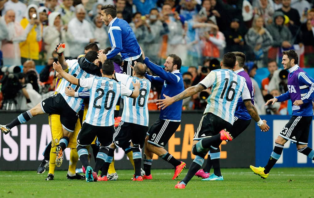 Argentinian players celebrate after the World Cup semifinal soccer match between the Netherlands and Argentina at the Itaquerao Stadium in Sao Paulo, Brazil.