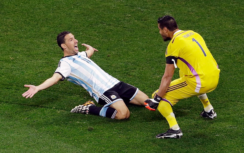 Argentina's Maxi Rodriguez celebrates with Argentina's goalkeeper Sergio Romero after scoring the last penalty during the World Cup semifinal soccer match between the Netherlands and Argentina at the Itaquerao Stadium in Sao Paulo Brazil.