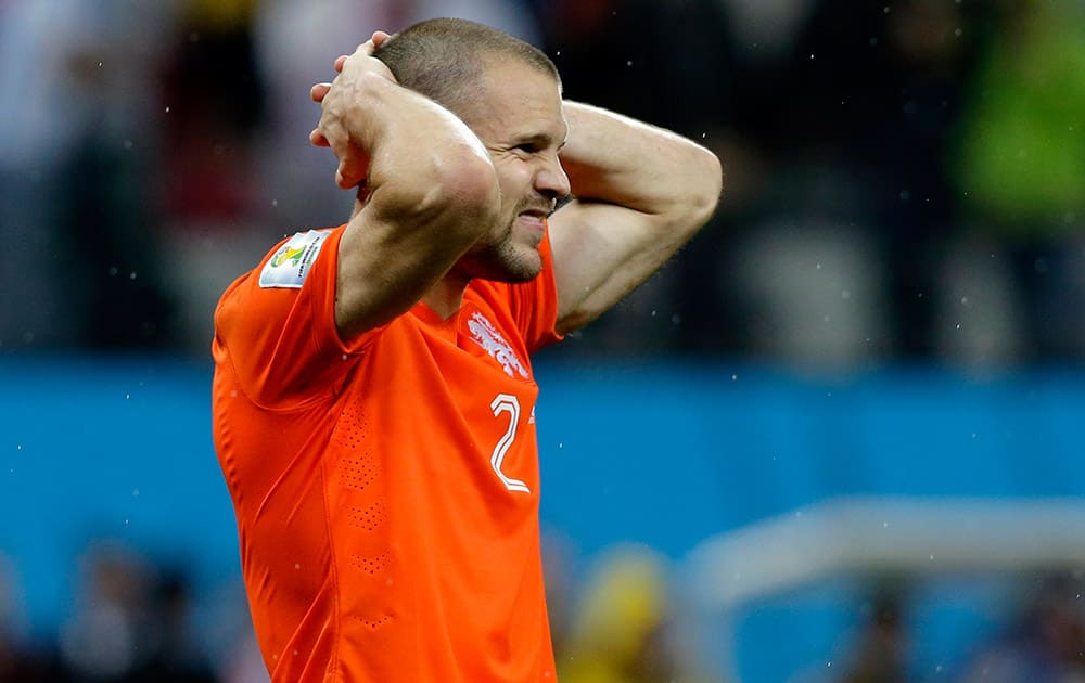 Netherlands' Ron Vlaar reacts after missing his shot during a penalty shootout after extra time during the World Cup semifinal soccer match between the Netherlands and Argentina at the Itaquerao Stadium in Sao Paulo Brazil.