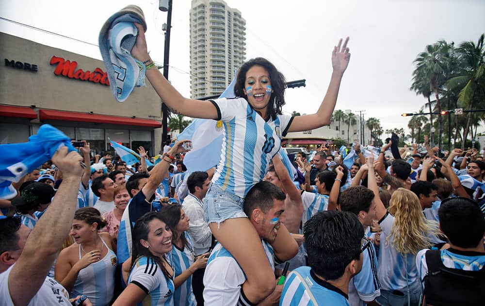 Soccer fans celebrate outside Manolo Restaurant in Miami Beach, Fla., after Argentina defeated the Netherlands 4-2 in a penalty shootout after a 0-0 tie after extra time to advance to the finals.