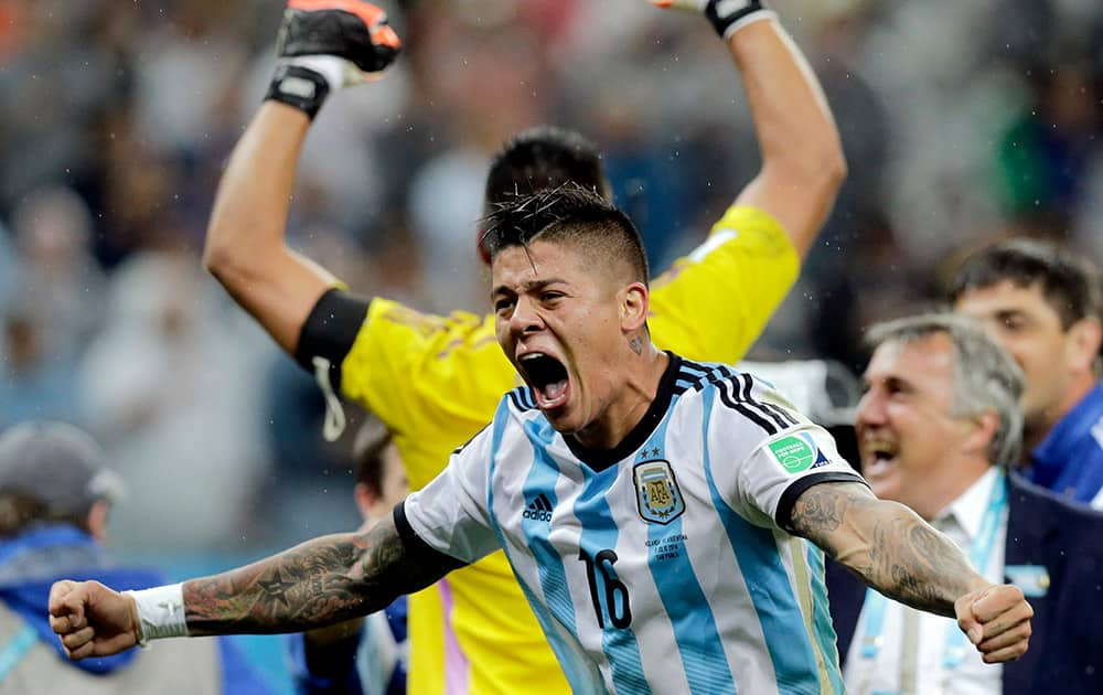 Argentina's Marcos Rojo celebrates after Argentina defeated the Netherlands 4-2 in a penalty shootout after a 0-0 tie after extra time to advance to the finals during the World Cup semifinal soccer match between the Netherlands and Argentina at the Itaquerao Stadium in Sao Paulo Brazil.