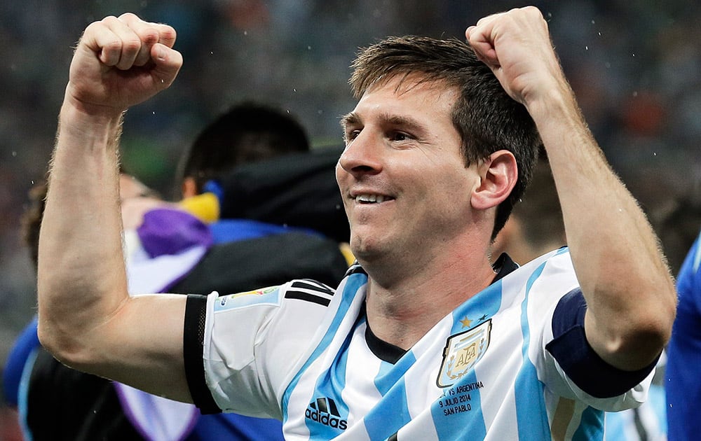 Argentina's Lionel Messi pumps his fists after Argentina defeated the Netherlands 4-2 in a penalty shootout after a 0-0 tie after extra time to advance to the finals after the World Cup semifinal soccer match between the Netherlands and Argentina at the Itaquerao Stadium in Sao Paulo Brazil.