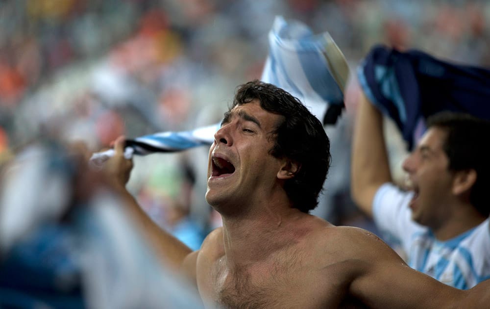 A fan of Argentina celebrates his team's victory over the Netherlands after the end of the semifinal match at the Itaquerao stadium during the 2014 soccer World Cup in Sao Paulo, Brazil.