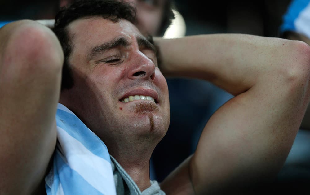 A fan of Argentina cries in disbelief over his team's victory over the Netherlands after the end of the semifinal match at the Itaquerao stadium during the 2014 soccer World Cup in Sao Paulo, Brazil.