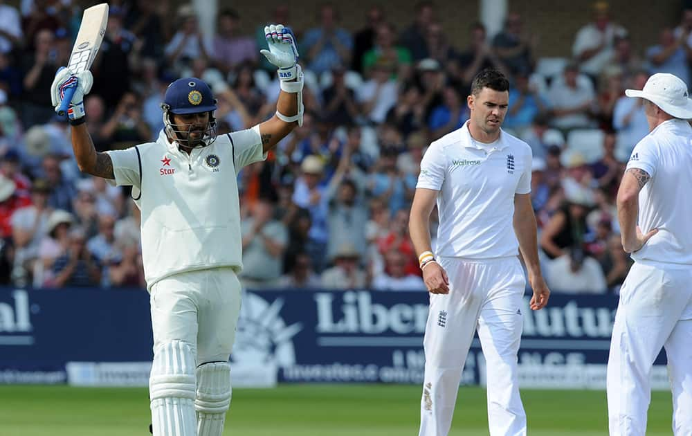 India's Murali Vijay celebrates after scoring a century watched by England's James Anderson, right, during day one of the first Test between England and India at Trent Bridge cricket ground, Nottingham.