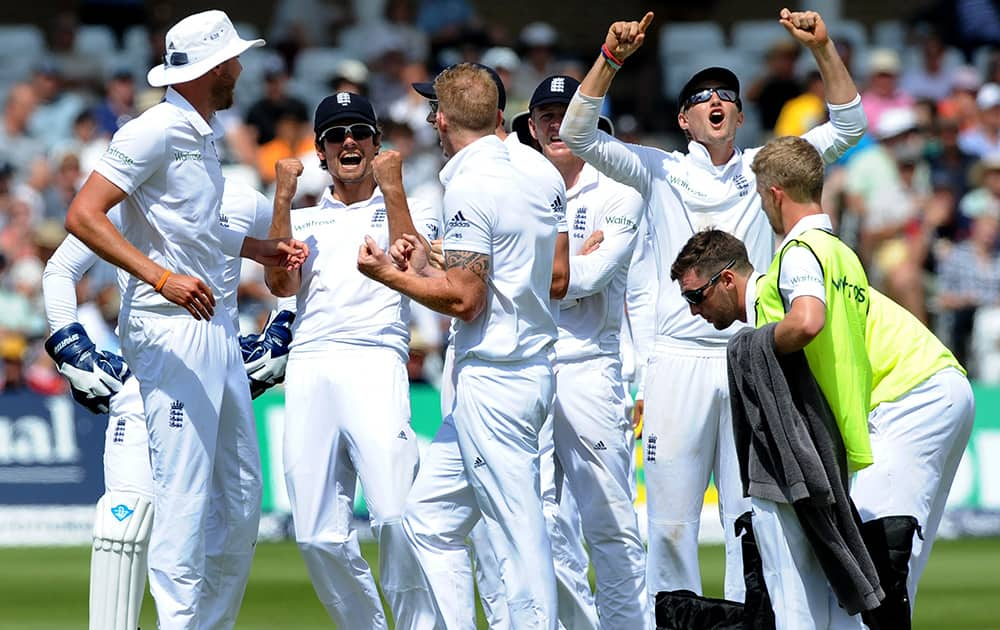 England's Alastair Cook celebrates with teammates after a successful run out appeal for India's M S Dhoni for 82 runs during day two of the first Test between England and India at Trent Bridge cricket ground, Nottingham, England.