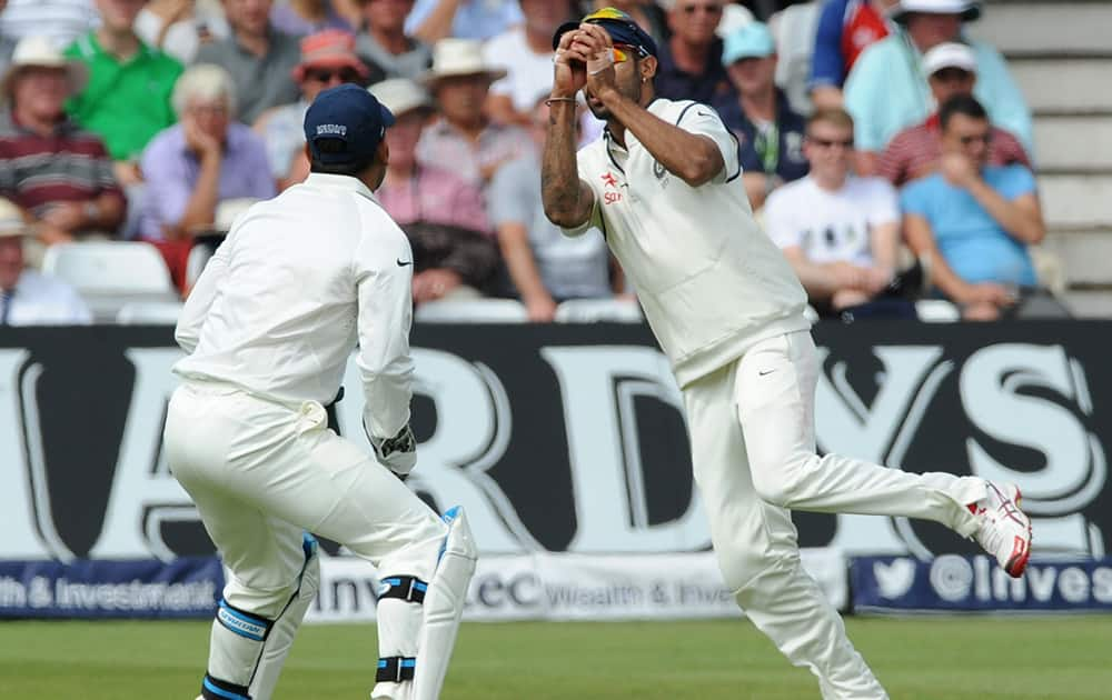 Shikhar Dhawan catches England's Moeen Ali bowled by India's Mohammed Shami for 14 runs during day three of the first Test between England and India at Trent Bridge cricket ground, Nottingham, England.