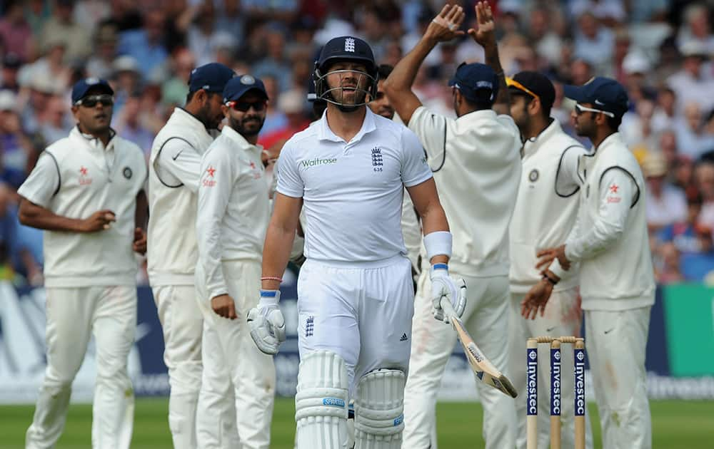 Matt Prior walks back to the pavilion after being bowled by India's Bhuvneshwar Kumar caught M. S. Dhoni for 5 runs during day three of the first Test between England and India at Trent Bridge cricket ground, Nottingham, England.