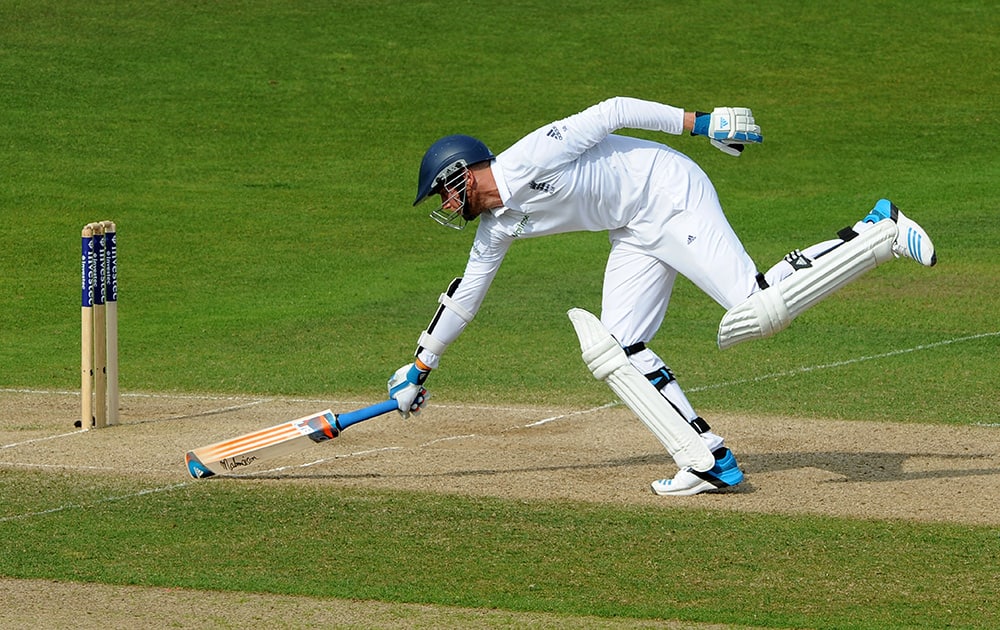 England's Stuart Broad stretches to avoid a run out during day three of the first Test between England and India at Trent Bridge cricket ground, Nottingham, England.