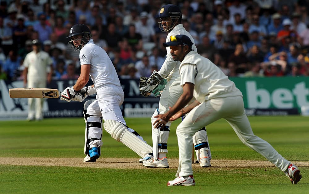 England's James Anderson, left, plays a reverse sweep shot during day three of the first Test between England and India at Trent Bridge cricket ground, Nottingham.