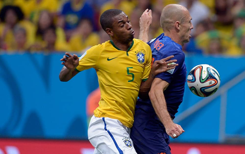 Netherlands' Arjen Robben, right, is challenged by Brazil's Fernandinho during the World Cup third-place soccer match between Brazil and the Netherlands at the Estadio Nacional in Brasilia, Brazil.