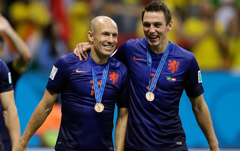 Netherlands' Arjen Robben, left and Stefan de Vrij walk together after medal presentations following their 3-0 victory over Brazil in the World Cup third-place soccer match between Brazil and the Netherlands at the Estadio Nacional in Brasilia, Brazil.