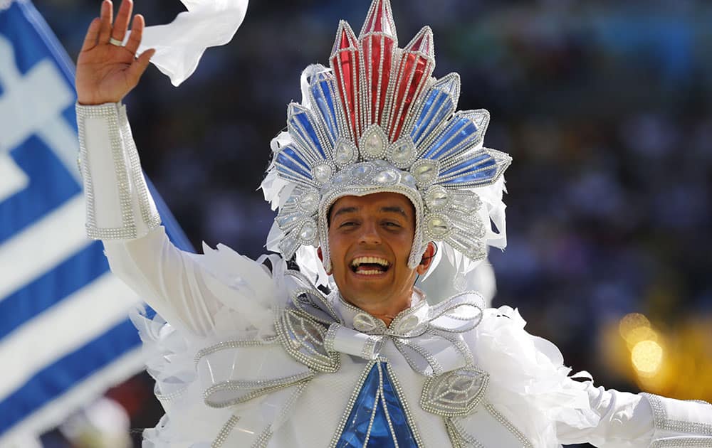 A performer waves during the closing ceremony for the World Cup before the final match between Germany and Argentina at Maracana Stadium in Rio de Janeiro, Brazil.