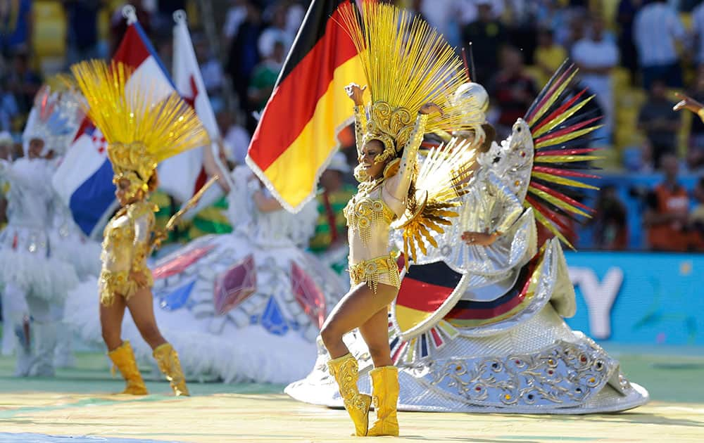 Dancers perform during in front of a German flag before the start of the World Cup final soccer match between Germany and Argentina at the Maracana Stadium in Rio de Janeiro, Brazil.