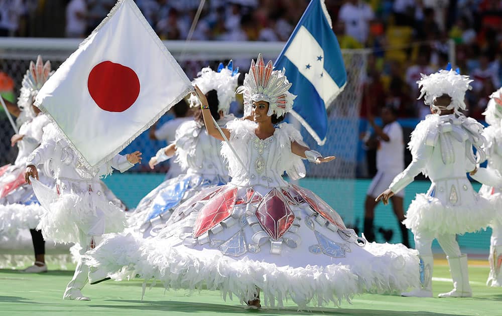 Dancers perform with a Japanese flag before the start of the World Cup final soccer match between Germany and Argentina at the Maracana Stadium in Rio de Janeiro, Brazil.