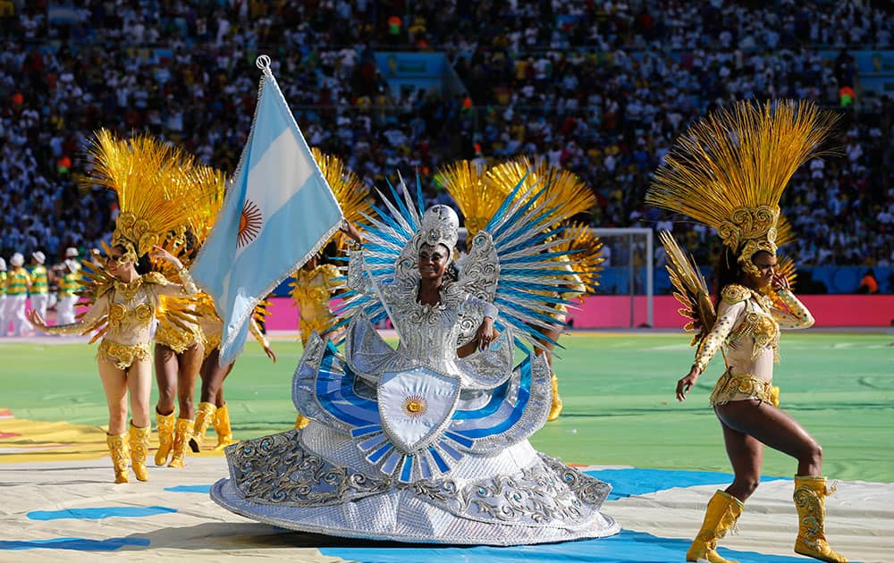 A performer carries the Argentine flag during the closing ceremony for the World Cup before the start of the final match between Germany and Argentina in Maracana Stadium in Rio de Janeiro