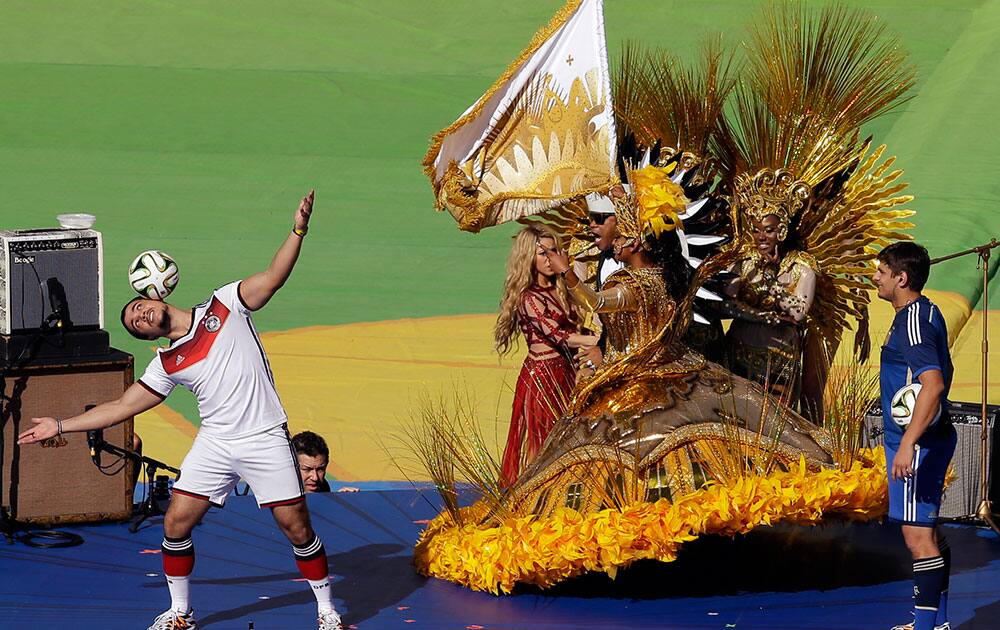 Colombian pop star Shakira, center in red, performs during the closing ceremony before the World Cup final soccer match between Germany and Argentina at the Maracana Stadium in Rio de Janeiro.