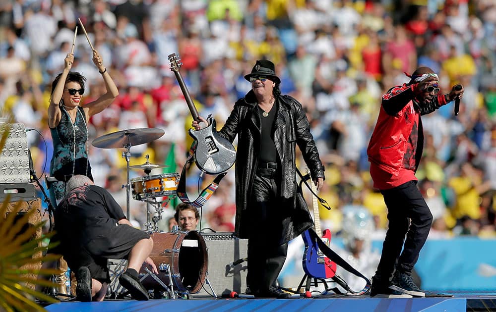 Musician Carlos Santana, centre, on stage during the closing ceremony before the World Cup final soccer match between Germany and Argentina at the Maracana Stadium in Rio de Janeiro, Brazil.