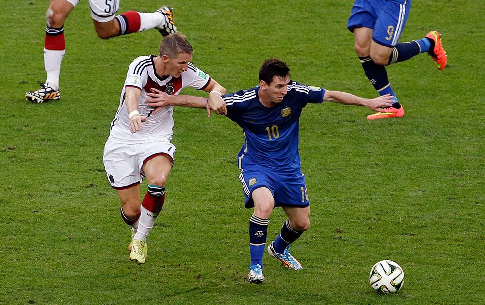 Argentina's Lionel Messi fights for the ball with Germany's Bastian Schweinsteiger during the World Cup final soccer match between Germany and Argentina at the Maracana Stadium in Rio de Janeiro, Brazil