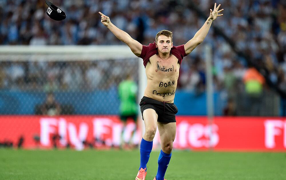 A man runs onto the pitch during the World Cup final soccer match between Germany and Argentina at the Maracana Stadium in Rio de Janeiro