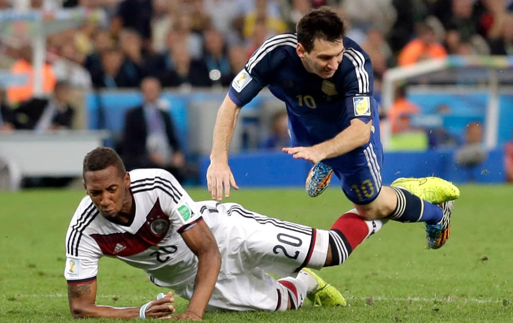 Argentina's Lionel Messi trips over Germany's Jerome Boateng during the World Cup final soccer match between Germany and Argentina at the Maracana Stadium in Rio de Janeiro, Brazil.