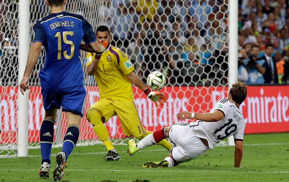 Germany's Mario Goetze, right, scores the opening goal past Argentina's goalkeeper Sergio Romero during the World Cup final soccer match between Germany and Argentina at the Maracana Stadium in Rio de Janeiro, Brazil.