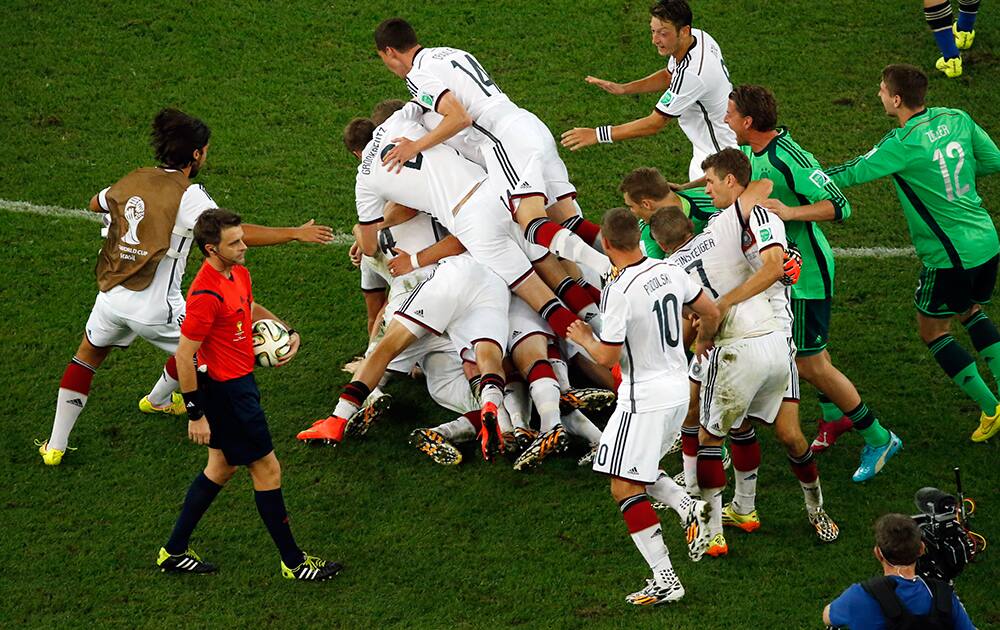 German players celebrate after the World Cup final soccer match between Germany and Argentina at the Maracana Stadium in Rio de Janeiro