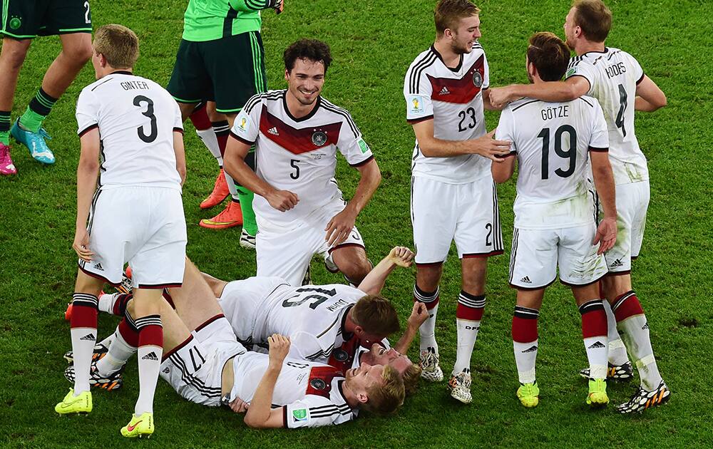 Germany's players celebrate after winning the World Cup final soccer match between Germany and Argentina at the Maracana Stadium in Rio de Janeiro