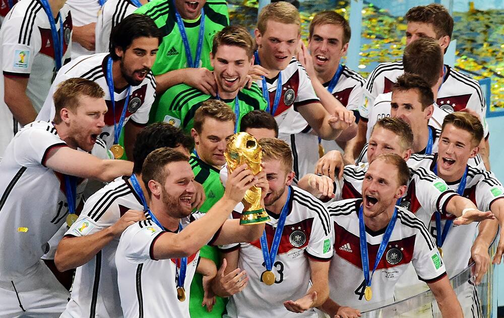 German players celebrate with the trophy after winning the World Cup final soccer match between Germany and Argentina at the Maracana Stadium in Rio de Janeiro.