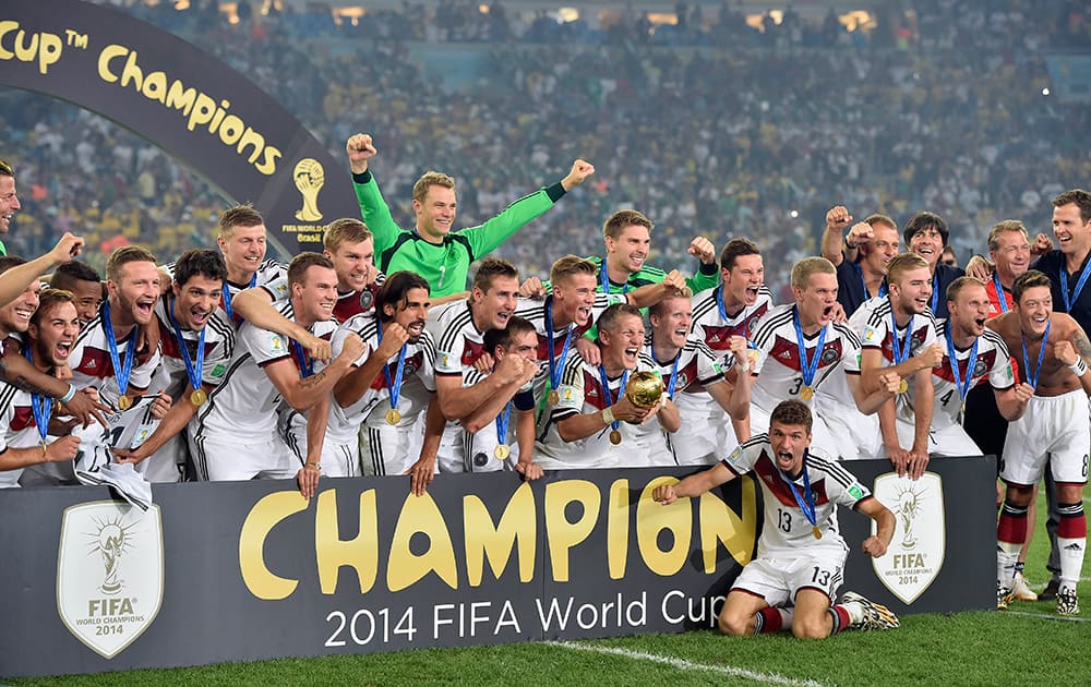 German players celebrate with the trophy after the World Cup final soccer match between Germany and Argentina at the Maracana Stadium in Rio de Janeiro.