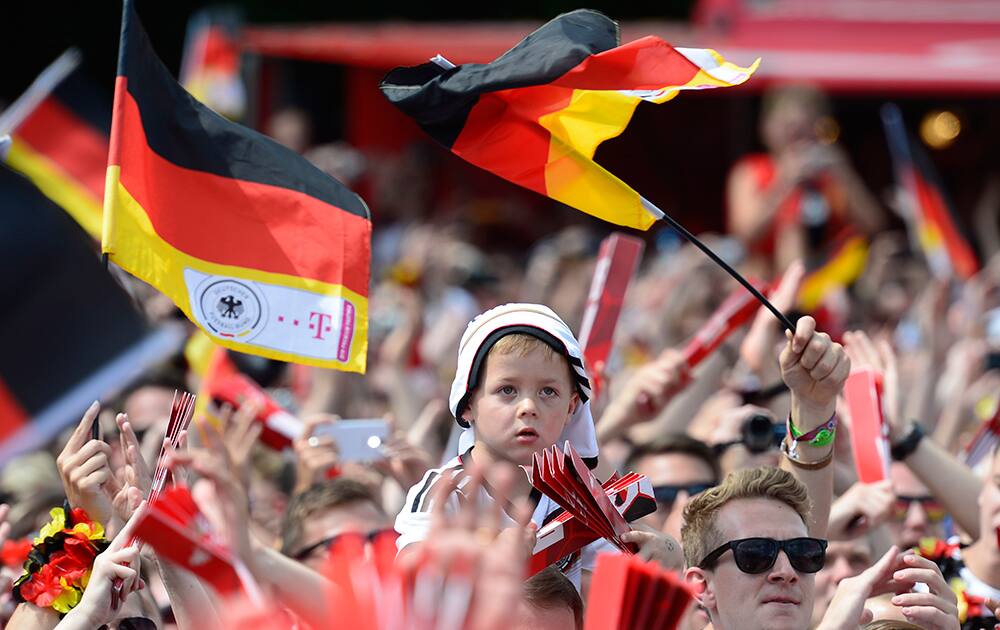 A boy waits for the arrival of the German national soccer team at the Brandenburg gate in Berlin.