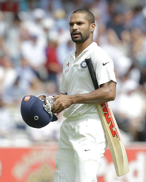 India's Shikhar Dhawan leaves the field after being caught by Gary Ballance off the bowling of England 's James Anderson during the first day of the second test match between England and India at Lord's cricket ground in London.