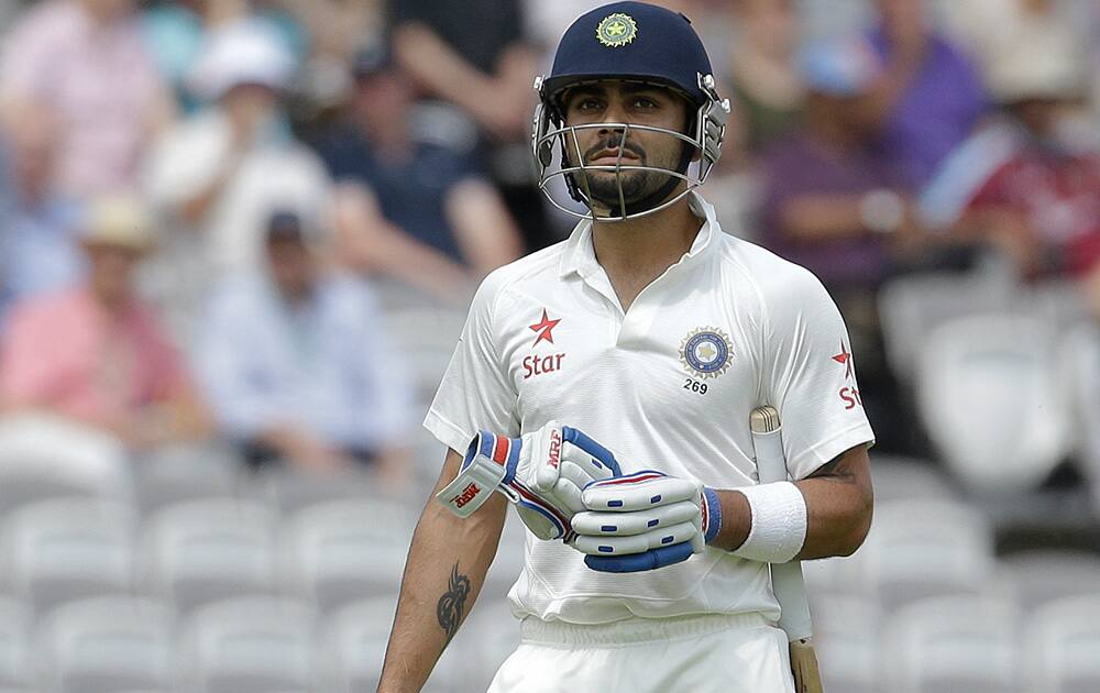 India's Virat Kohli leaves the field after being caught by Matt Prior off the bowling of England's James Anderson during the first day of the second test match between England and India at Lord's cricket ground in London.