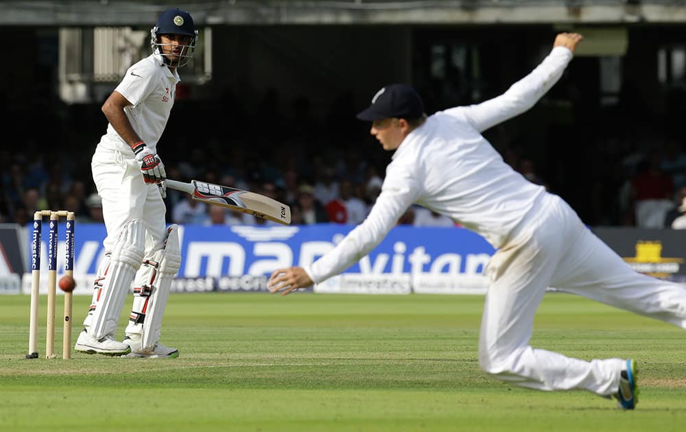 Bhuvneshwar Kumar plays a shot off the bowling of England's Ben Stokes as Joe Root leaps to catch during the first day of the second test match between England and India at Lord's cricket ground in London.