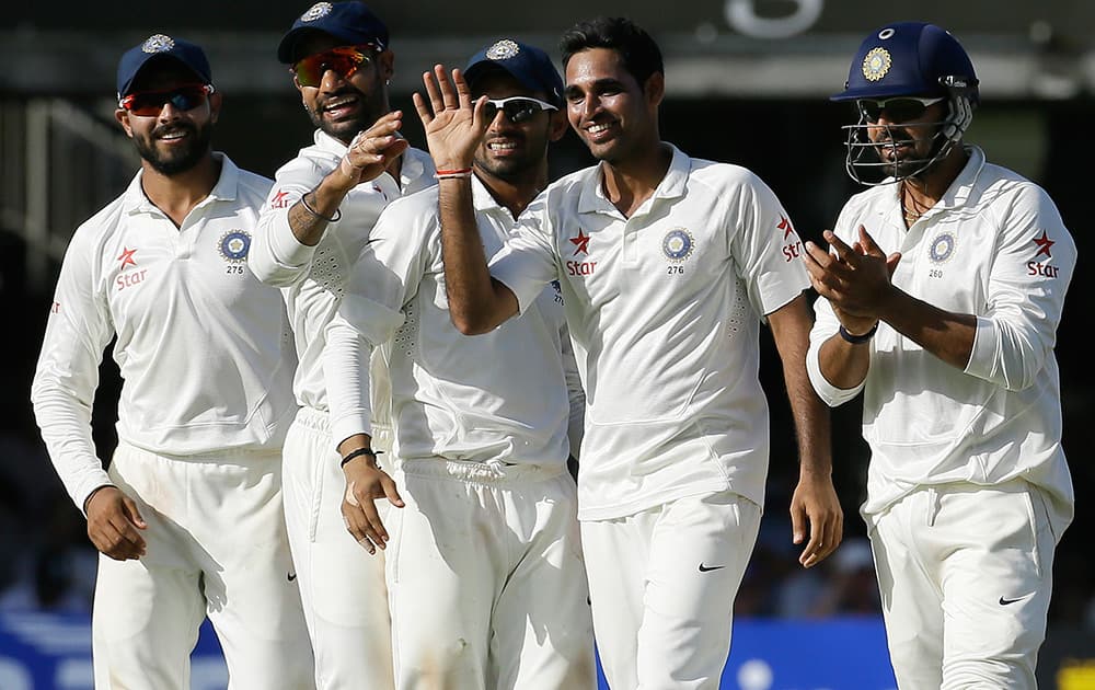 India's Bhuvneshwar Kumar celebrates with teammates the wicket of England's Gary Ballance, during the second day of the second test match between England and India at Lord's cricket ground in London.