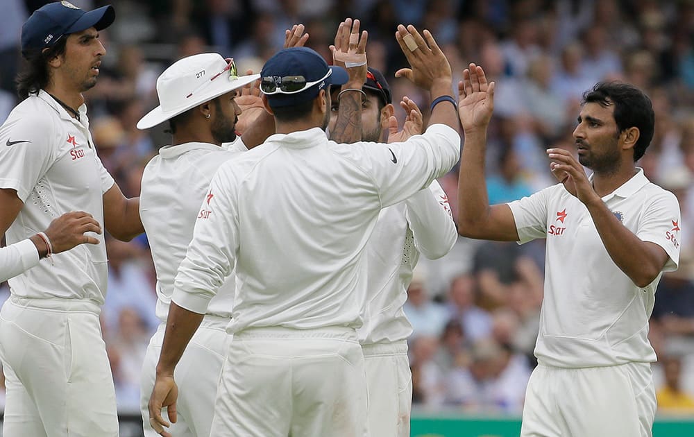 India's players celebrate the wicket of England's Matt Prior during the third day of the second test match between England and India at Lord's cricket ground in London.