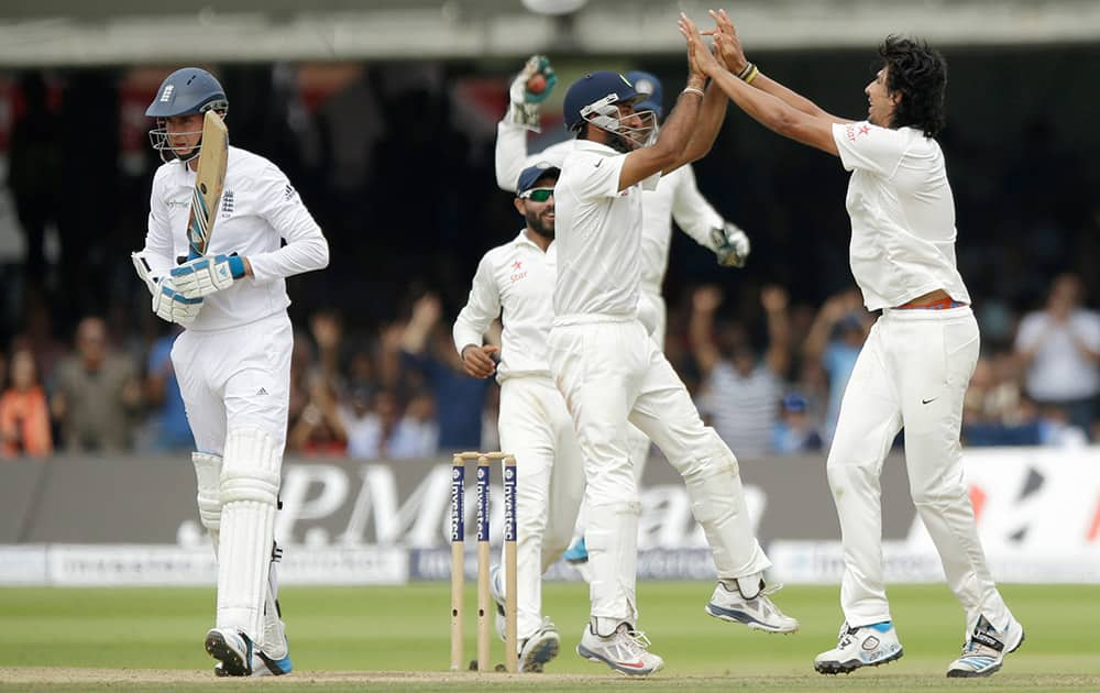 India's Ishant Sharma, right, celebrates with his teammates after taking the wicket of England's Stuart Broad, left, during the test match on the fifth day of the second cricket test match between England and India at Lord's cricket ground in London.