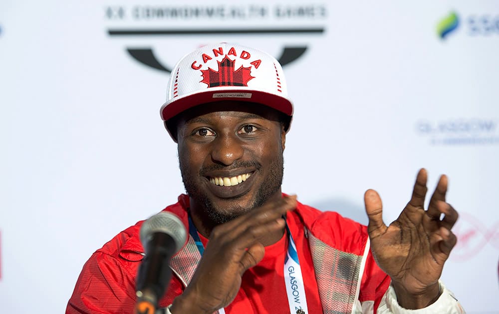 Canadian boxer Custio Clayton talks with reporters during a news conference at the Commonwealth Games in Glasgow, Scotland.