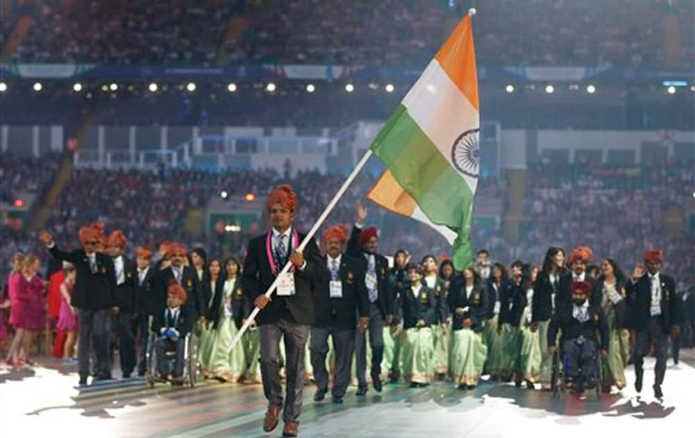 India’s flag bearer Vijay Kumar leads his team during the opening ceremony for the Commonwealth Games 2014 in Glasgow, Scotland.