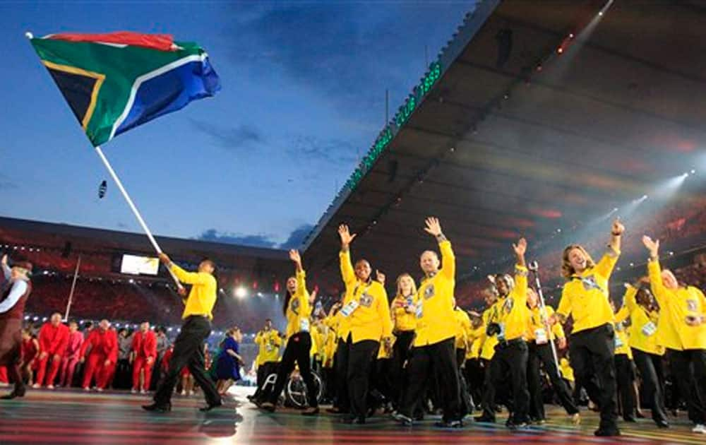 South Africa’s flag bearer Cecil Sebastian Afrika leads the team into the arena during the opening ceremony for the Commonwealth Games 2014 in Glasgow.