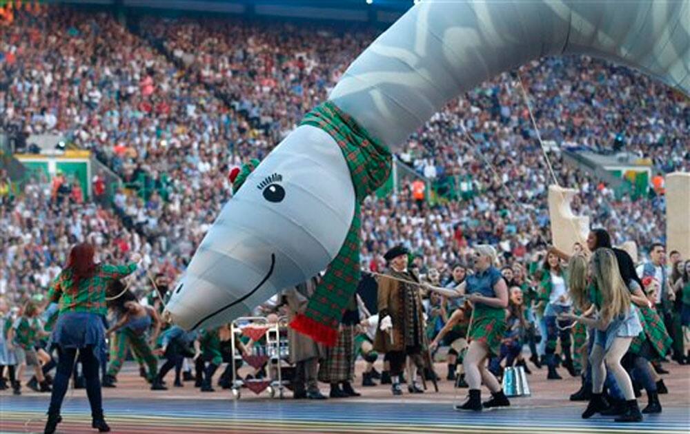 Performers dance with an effigy of the Loch Ness Monster during the opening ceremony for the Commonwealth Games 2014.