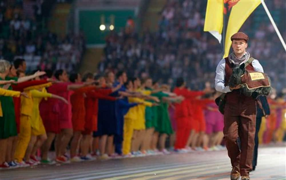 A host carries a Scottish Terrier during the opening ceremony for the Commonwealth Games 2014 in Glasgow, Scotland.