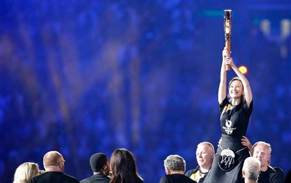 The Queen's Baton is shown to the crowd as it arrives in the stadium during the opening ceremony for the Commonwealth Games 2014.