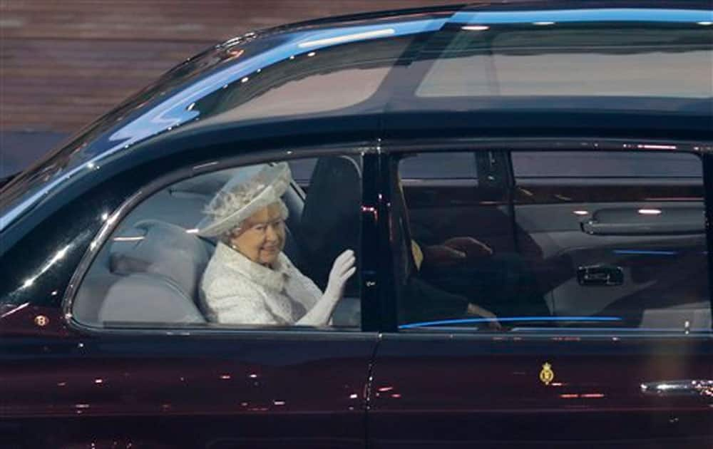 Britain's Queen Elizabeth II waves as she arrives in the stadium during the opening ceremony for the Commonwealth Games 2014.