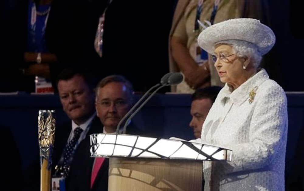 Britain's Queen Elizabeth II reads the message from the Queen's baton during the opening ceremony for the Commonwealth Games 2014 in Glasgow.