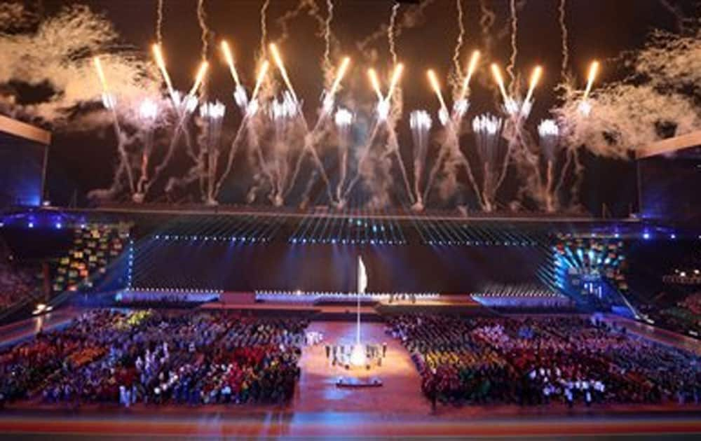 Fireworks explode during the flag raising at the opening ceremony for the Commonwealth Games 2014 in Glasgow, Scotland.